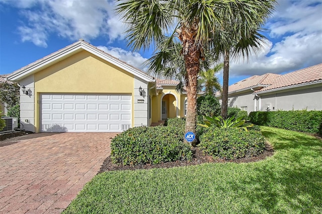 view of front of property with a garage and central air condition unit