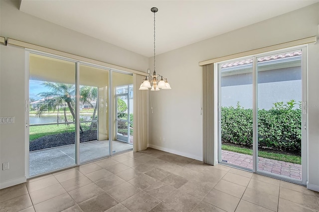 interior space featuring a water view, a notable chandelier, and light tile patterned flooring