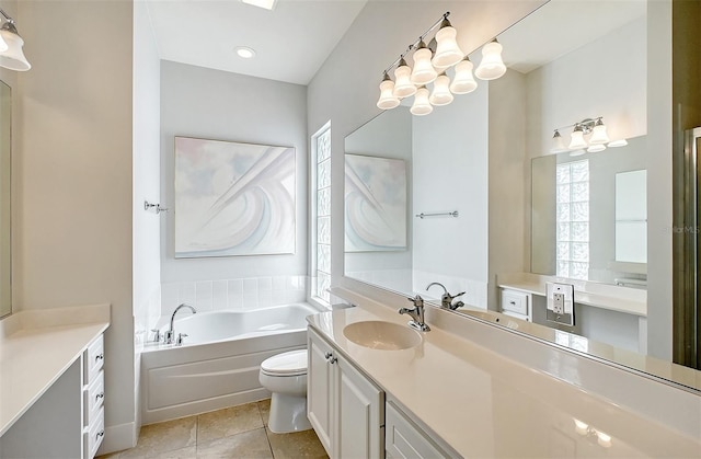 bathroom with a tub, tile patterned flooring, vanity, and toilet