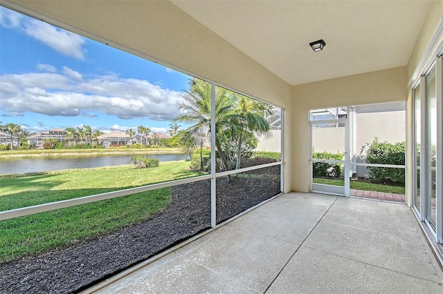 unfurnished sunroom featuring a water view