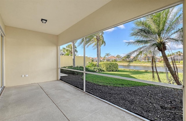 unfurnished sunroom with a water view