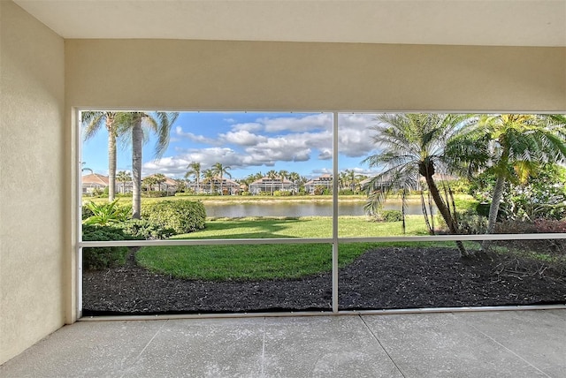 unfurnished sunroom with a water view