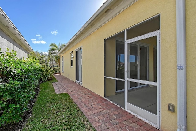 view of home's exterior with a sunroom