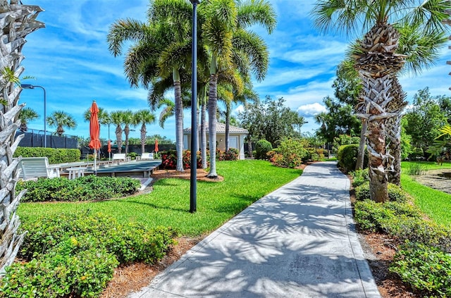 view of property's community with a lawn