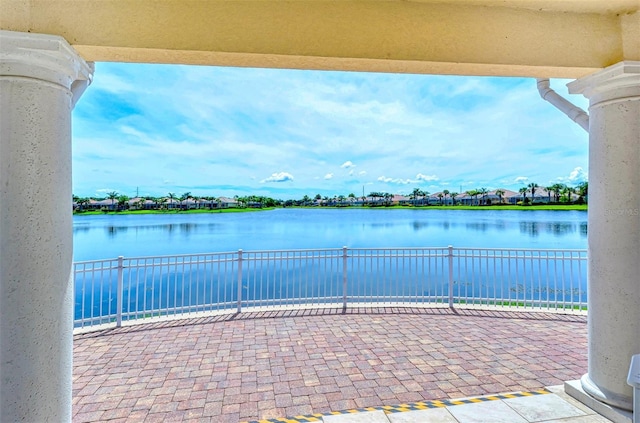 view of patio with a water view