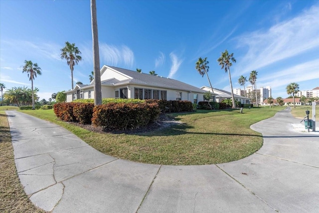 view of side of property with a yard