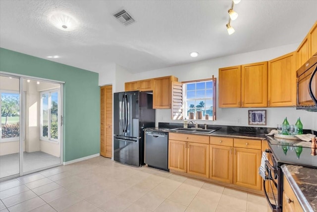 kitchen with black appliances, sink, and a textured ceiling