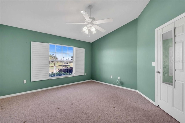 carpeted spare room with ceiling fan