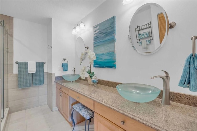 bathroom featuring walk in shower, vanity, tile patterned floors, and tile walls