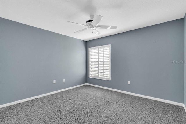 spare room with ceiling fan and carpet