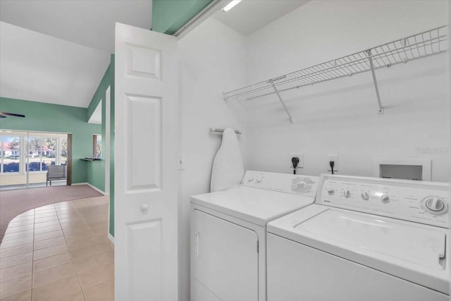 washroom featuring washing machine and dryer and light tile patterned floors