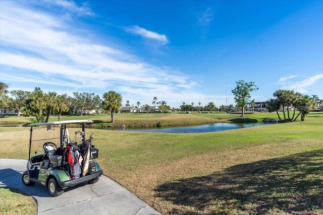 view of property's community with a yard and a water view