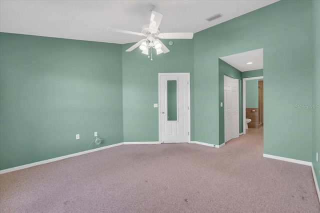 unfurnished room with ceiling fan and light carpet