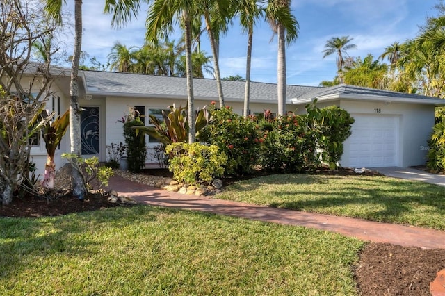 ranch-style house with a front yard and a garage