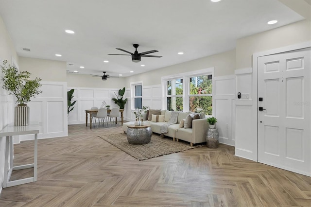 unfurnished living room with ceiling fan and light parquet flooring