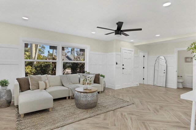 living room featuring light parquet floors and ceiling fan