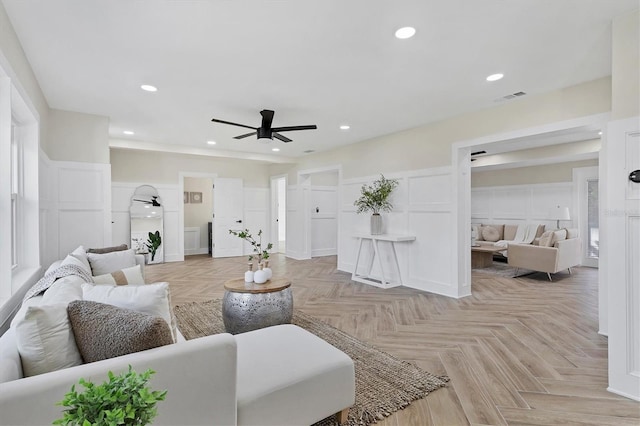 living room featuring ceiling fan and light parquet flooring