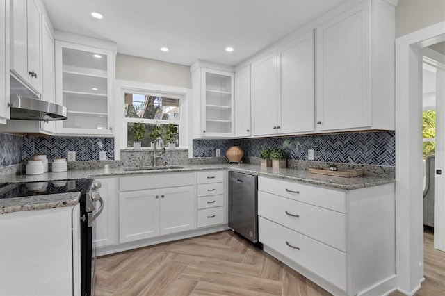 kitchen featuring appliances with stainless steel finishes, light stone counters, light parquet floors, sink, and white cabinets