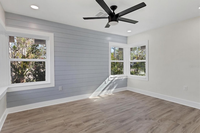 empty room featuring light wood-type flooring and ceiling fan