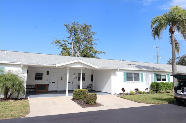 ranch-style home with a front yard and a carport