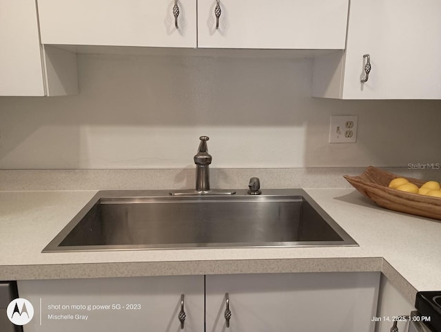 interior details with sink and white cabinets