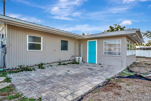 exterior space with ac unit and a patio