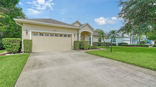 view of front facade with a garage and a front lawn