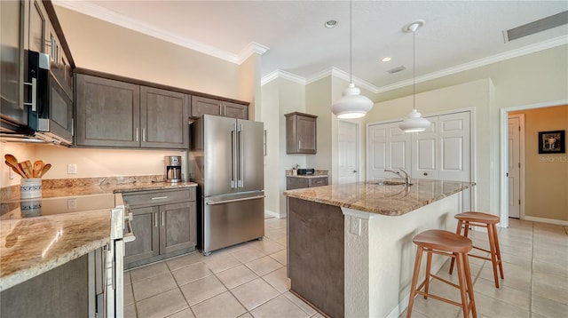 kitchen with light stone countertops, high end fridge, pendant lighting, and ornamental molding