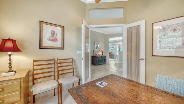 hallway with crown molding and light tile patterned floors