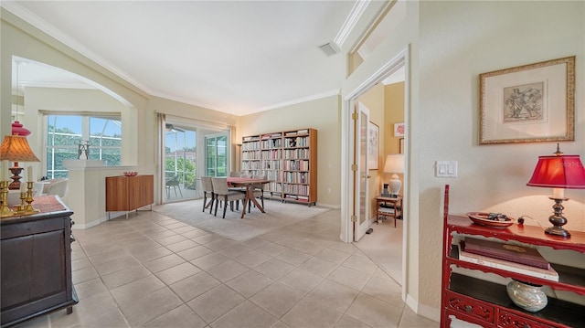 living area with light tile patterned flooring and ornamental molding