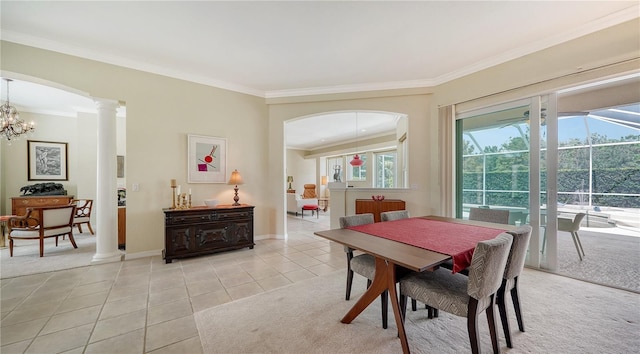 dining area with crown molding, light tile patterned flooring, and an inviting chandelier