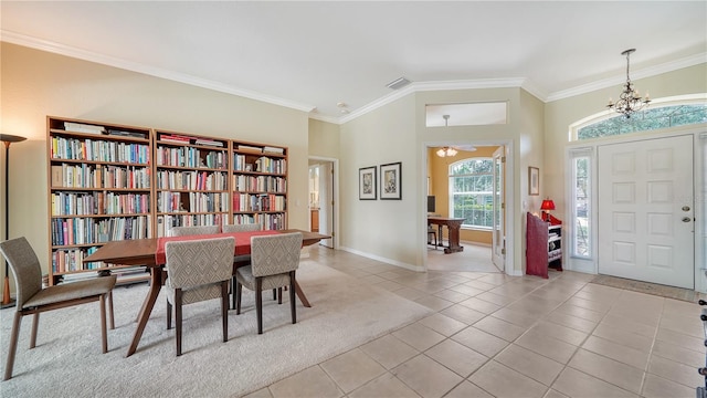 interior space featuring light tile patterned floors, a chandelier, and ornamental molding