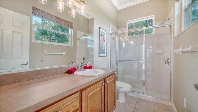 bathroom featuring tile patterned floors, vanity, a healthy amount of sunlight, and ornamental molding