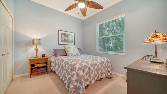 bedroom with multiple windows, a closet, ornamental molding, and ceiling fan