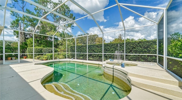 view of swimming pool with a patio and a lanai