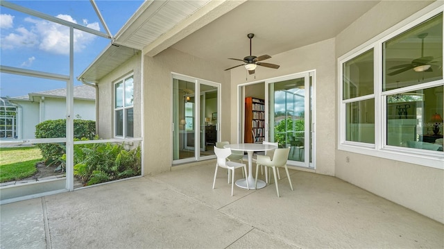 unfurnished sunroom featuring ceiling fan