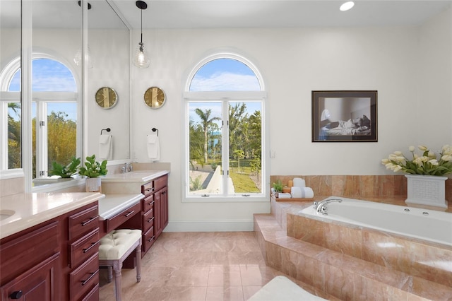 bathroom featuring vanity and a relaxing tiled tub