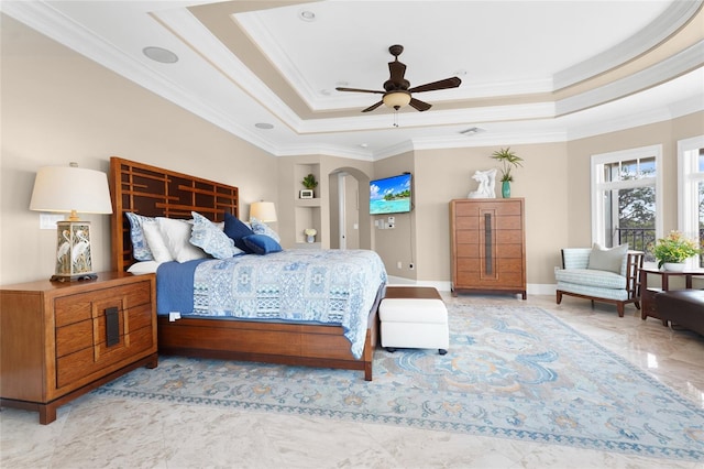 bedroom featuring crown molding, a tray ceiling, and ceiling fan