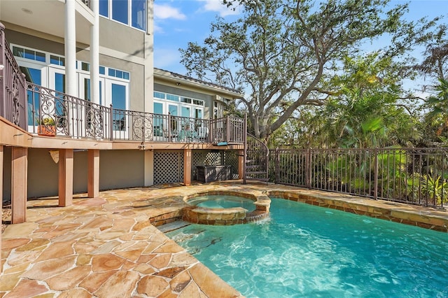 view of pool with a patio and an in ground hot tub