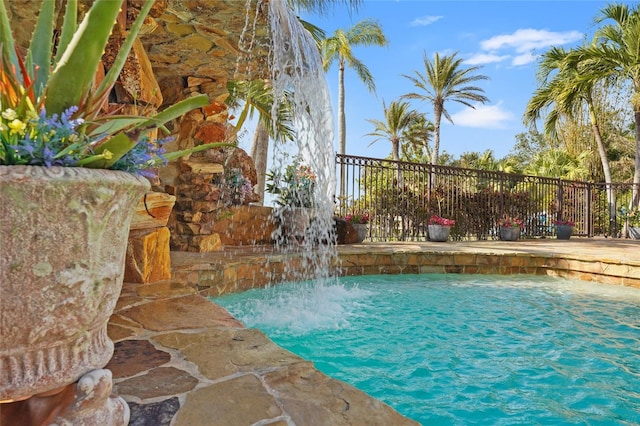 view of pool with pool water feature