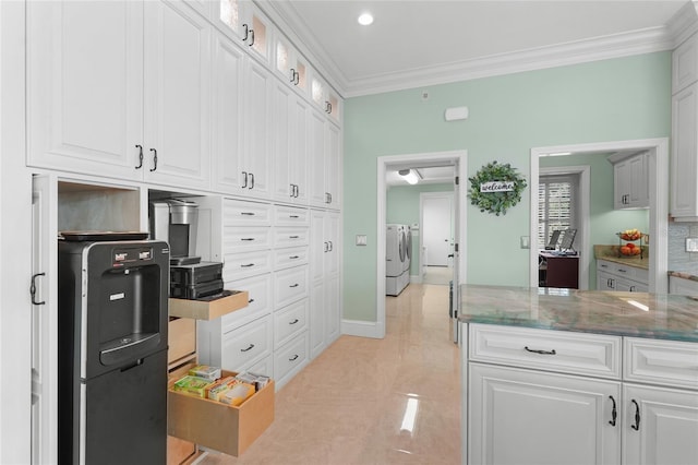 kitchen with separate washer and dryer, white cabinetry, and stone counters