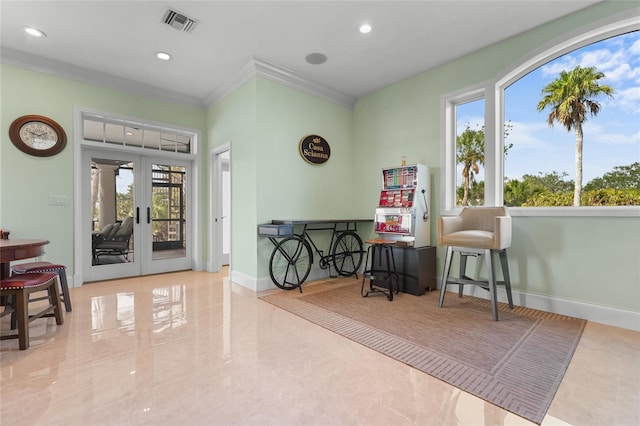 sitting room with ornamental molding and french doors