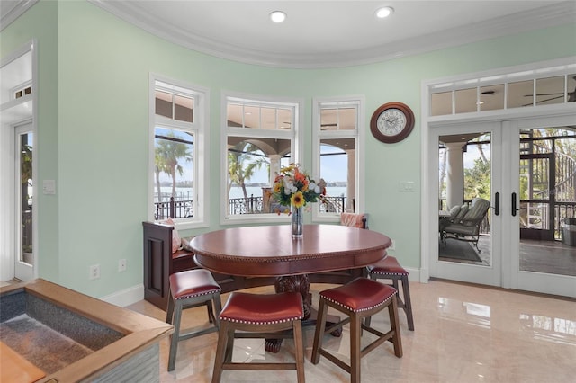 dining area featuring ornamental molding and french doors