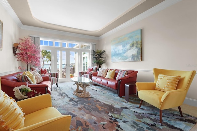 living room with a raised ceiling, ornamental molding, carpet, and french doors