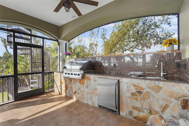 view of patio with ceiling fan, area for grilling, and sink