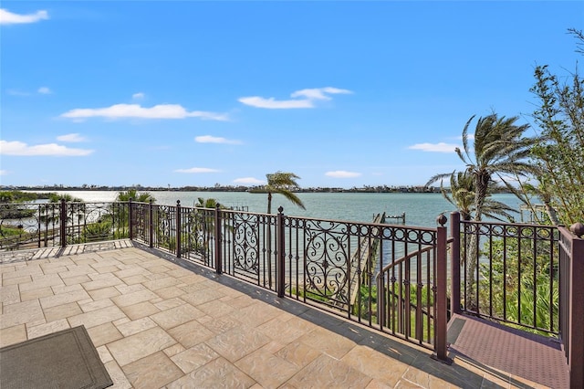 view of patio / terrace featuring a water view and a balcony