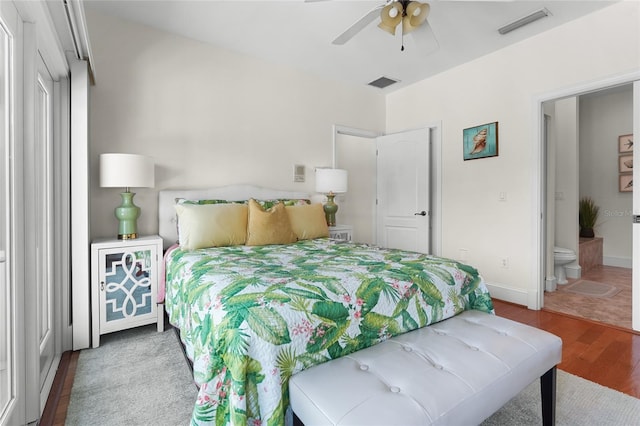 bedroom with hardwood / wood-style floors, ensuite bathroom, and ceiling fan