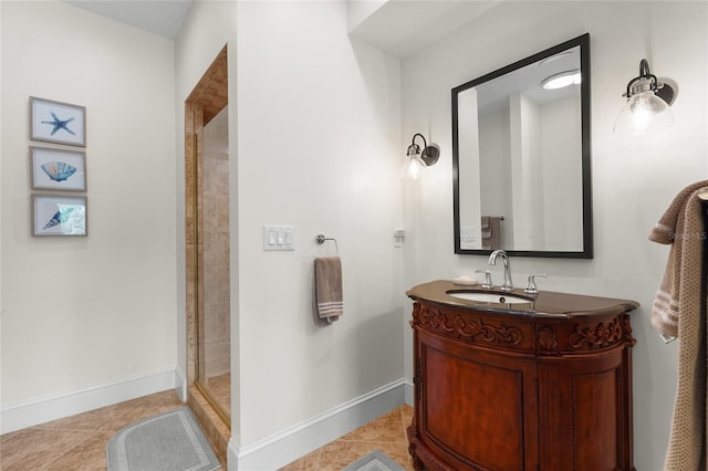 bathroom featuring tiled shower, tile patterned flooring, and vanity