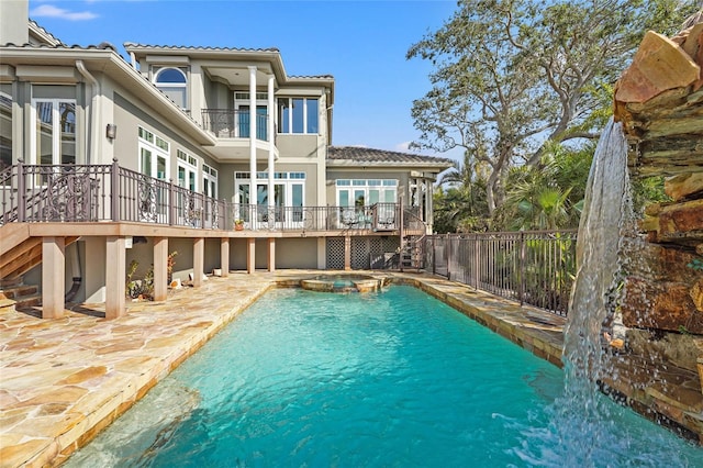 view of swimming pool featuring a patio area, an in ground hot tub, and pool water feature