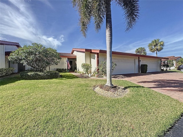 view of front of property featuring a garage and a front lawn